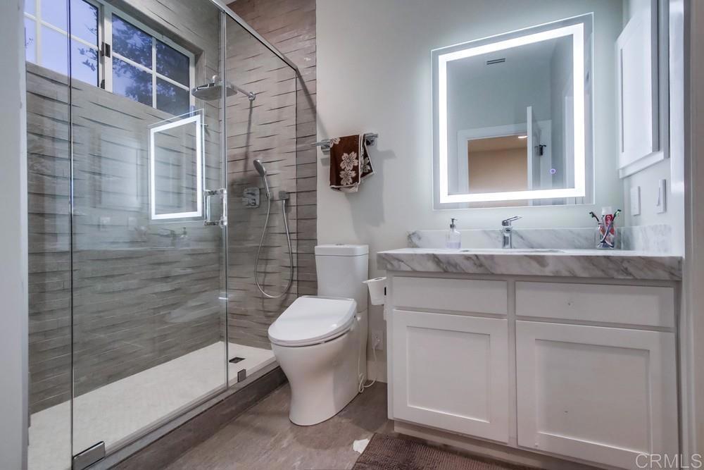 4124 Stonebridge Lane Rancho Santa Fe, CA 92091 - Photo 26 of 31 a bathroom with a granite countertop sink a toilet and mirror