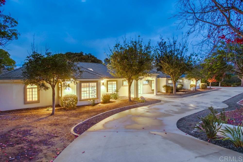 4124 Stonebridge Lane Rancho Santa Fe, CA 92091 - Photo 31 of 31 a front view of a house with a yard and tree s