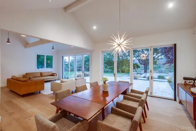 a dining room with furniture and a large window