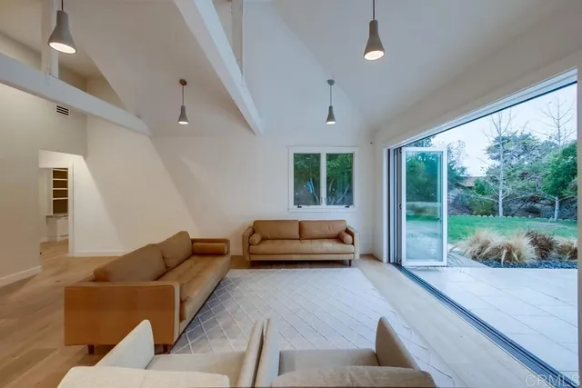 a room with a wooden floor and windows