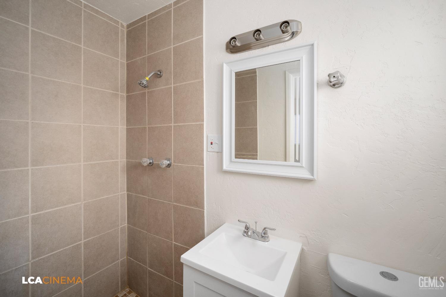 Undisclosed Address Earlimart, CA 93219 - Photo 15 of 18 a bathroom with a toilet sink shower and mirror