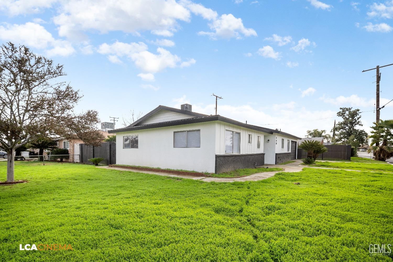 Undisclosed Address Earlimart, CA 93219 - Photo 3 of 18 a big white house with a big yard and large trees