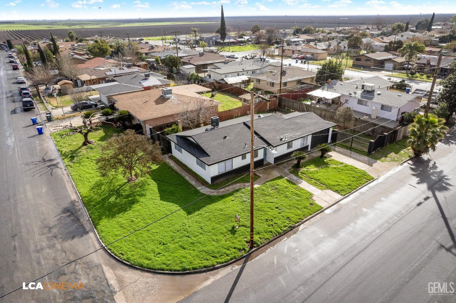 Undisclosed Address Earlimart, CA 93219 - Photo 4 of 18 an aerial view of a house with a garden and lake view