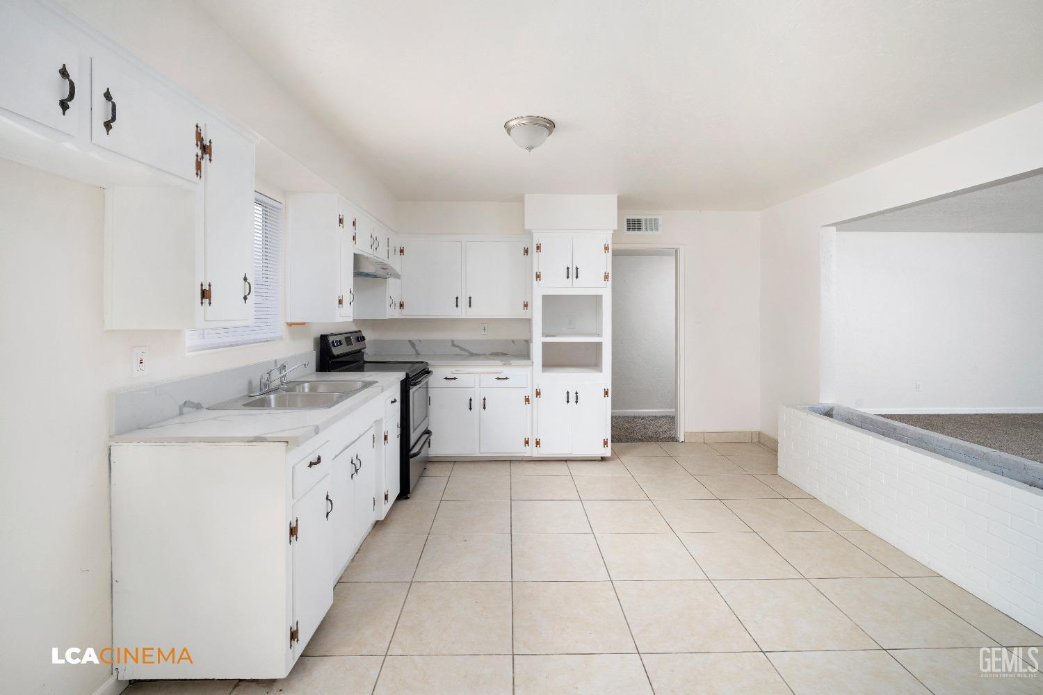 Undisclosed Address Earlimart, CA 93219 - Photo 9 of 18 a kitchen with cabinets and window