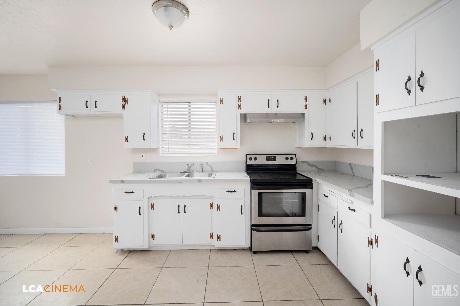 Undisclosed Address Earlimart, CA 93219 - Photo 10 of 18 a kitchen with granite countertop white cabinets and appliances