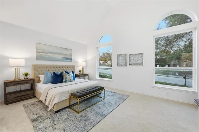 a bedroom with a bed lamp and window
