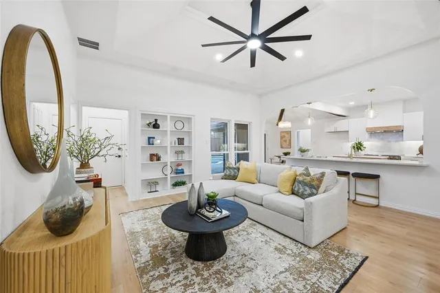 a living room with furniture and a wooden floor