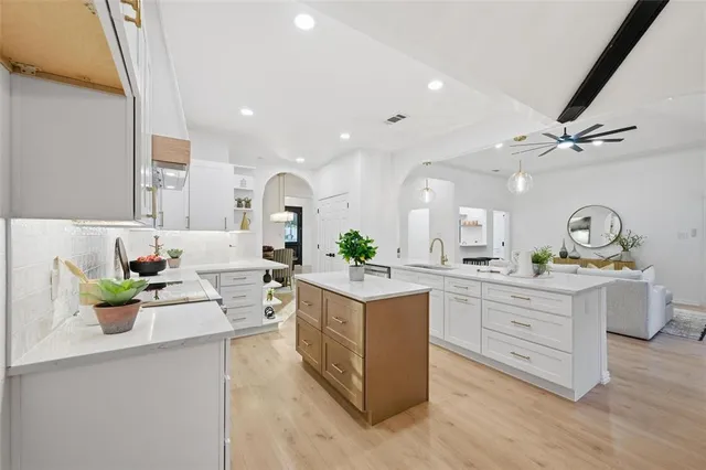 a view of a kitchen with cabinets and wooden floor