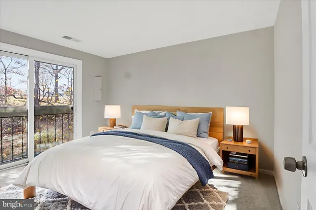 a bedroom with a bed and large window