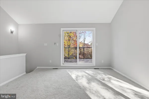 an empty room with large windows