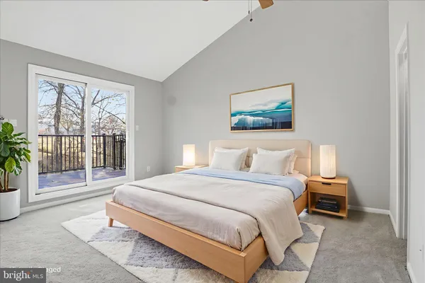 a bedroom with a balcony a bed and a painting on the wall