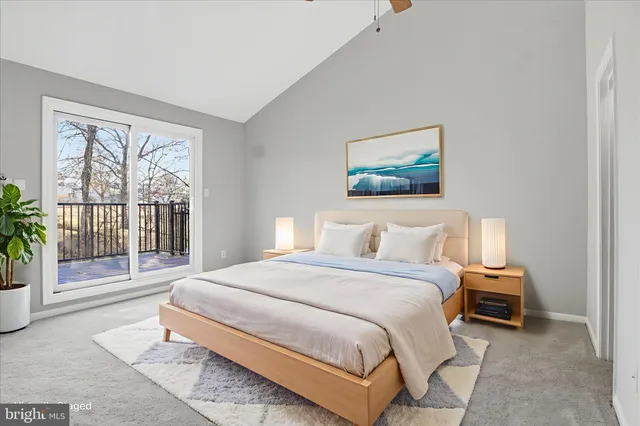 a bedroom with a balcony a bed and a painting on the wall