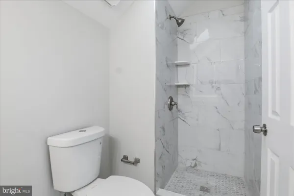 a white toilet sitting next to a bathroom