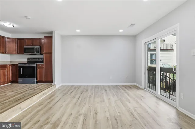 a view of kitchen with wooden floor and electronic appliances