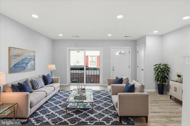 a living room with furniture and a potted plant