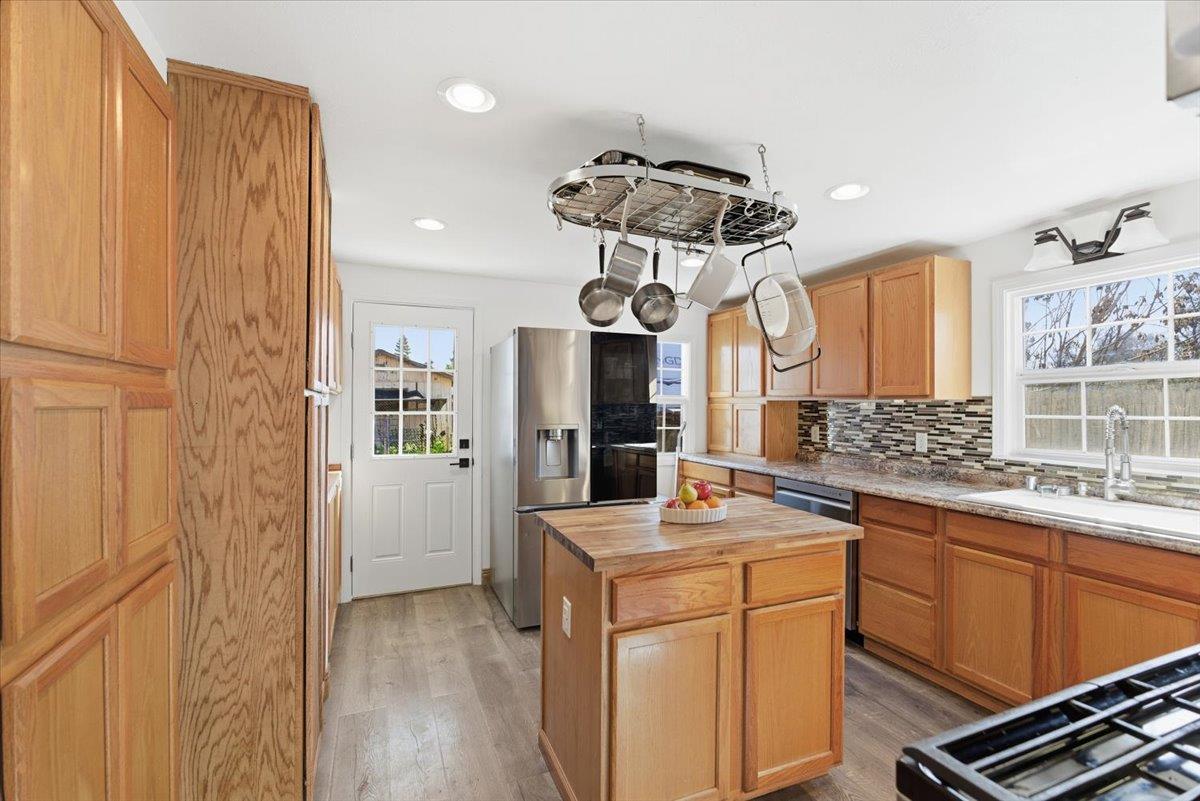 1939 1st Avenue Sutter, CA 95982 - Photo 16 of 35 a kitchen that has a lot of cabinets in it and wooden floors