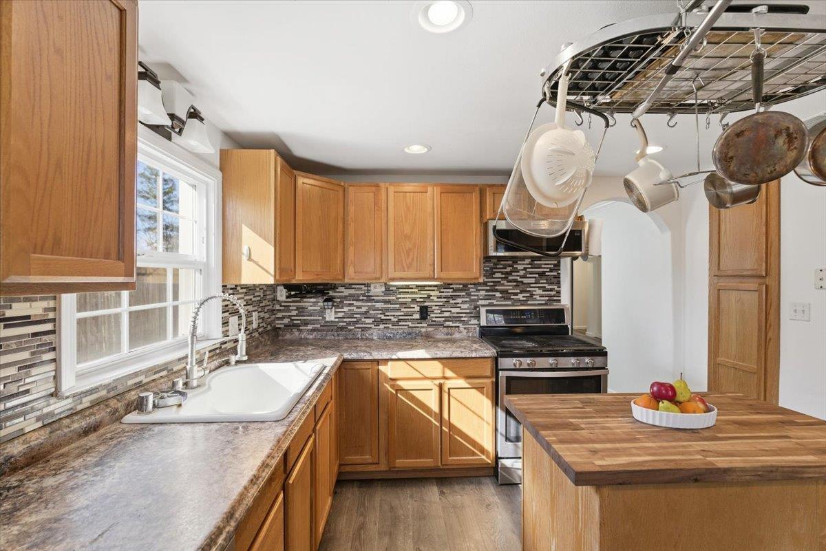 1939 1st Avenue Sutter, CA 95982 - Photo 18 of 35 a kitchen with stainless steel appliances granite countertop a sink a stove and a wooden floors
