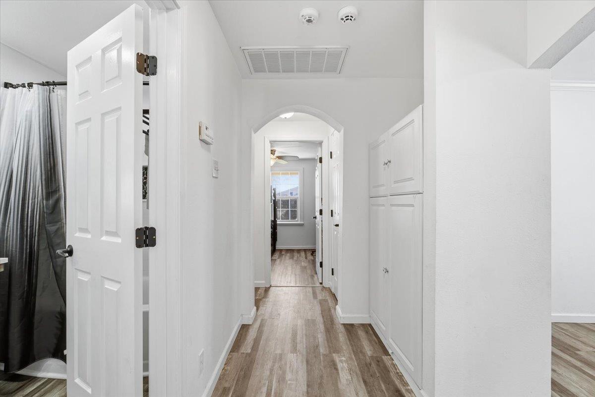 1939 1st Avenue Sutter, CA 95982 - Photo 19 of 35 a view of a hallway with wooden floor and a bathroom