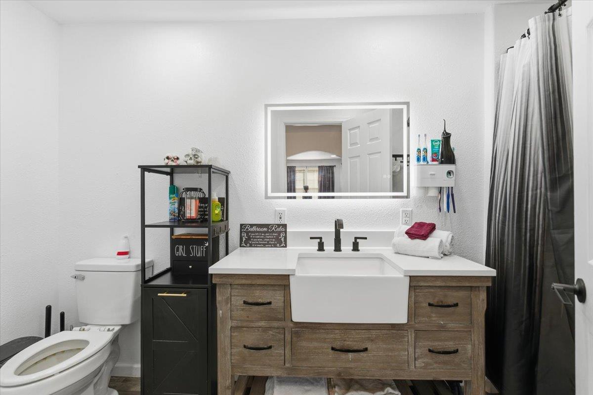 1939 1st Avenue Sutter, CA 95982 - Photo 21 of 35 a bathroom with a sink toilet and mirror