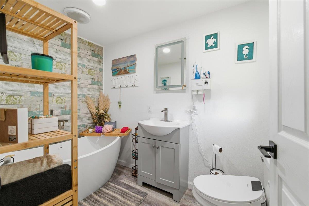 1939 1st Avenue Sutter, CA 95982 - Photo 27 of 35 a bathroom with a bathtub sink mirror vanity and toilet