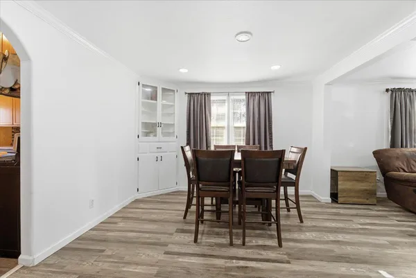a view of a dining room with furniture and wooden floor