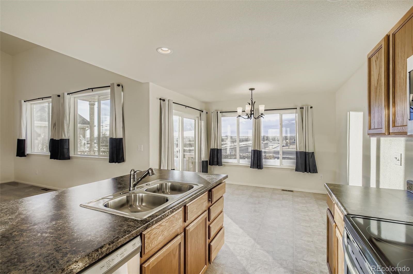 10300 19th St Road Greeley, CO 80634 - Photo 12 of 33 a large kitchen with stainless steel appliances a large window and a counter space