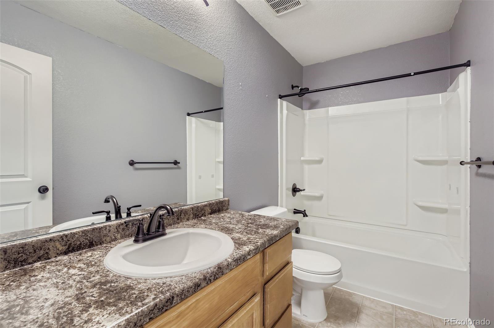 10300 19th St Road Greeley, CO 80634 - Photo 22 of 33 a bathroom with a granite countertop sink toilet and shower