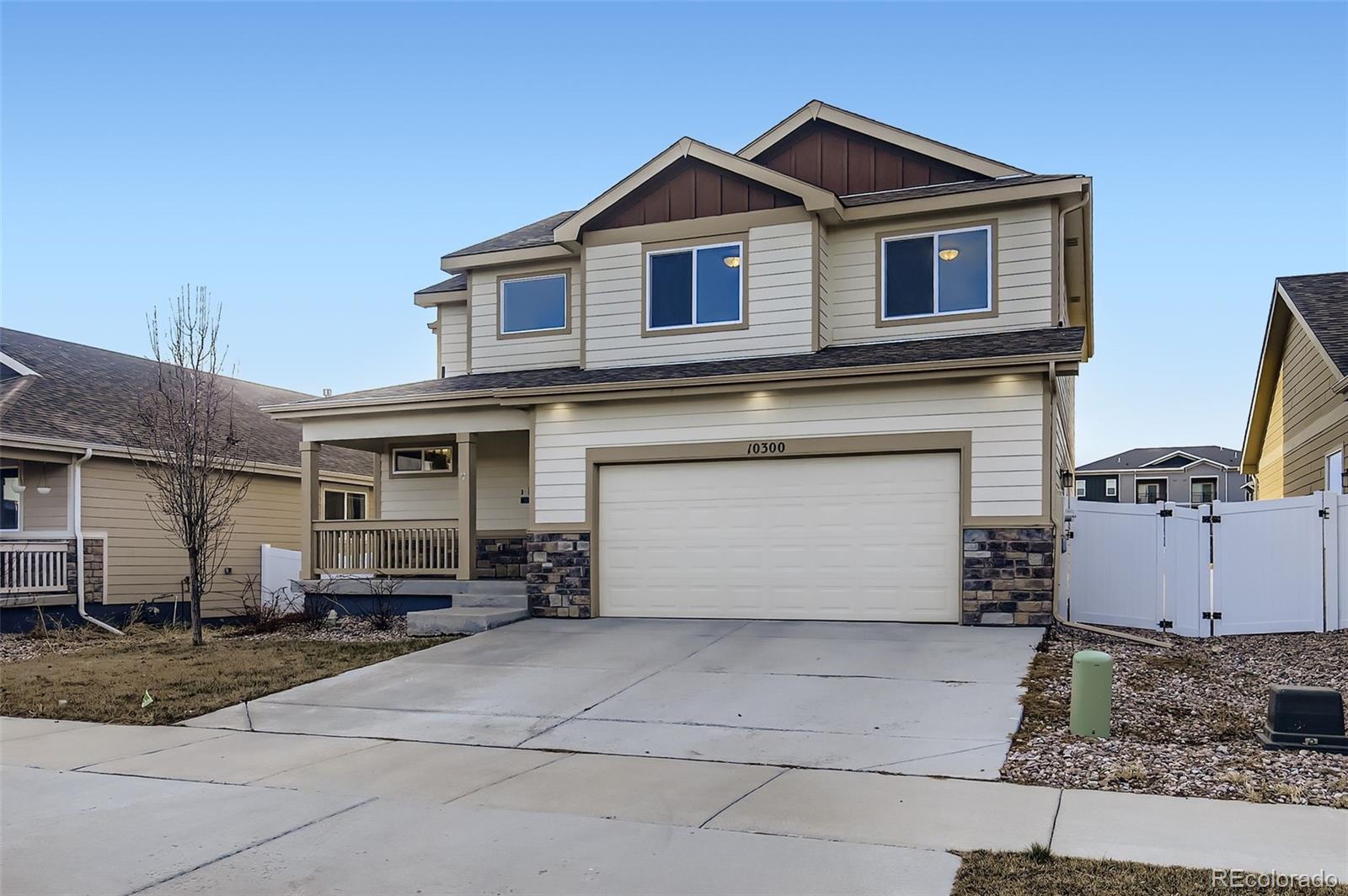 10300 19th St Road Greeley, CO 80634 - Photo 3 of 33 a front view of a house with a yard and garage