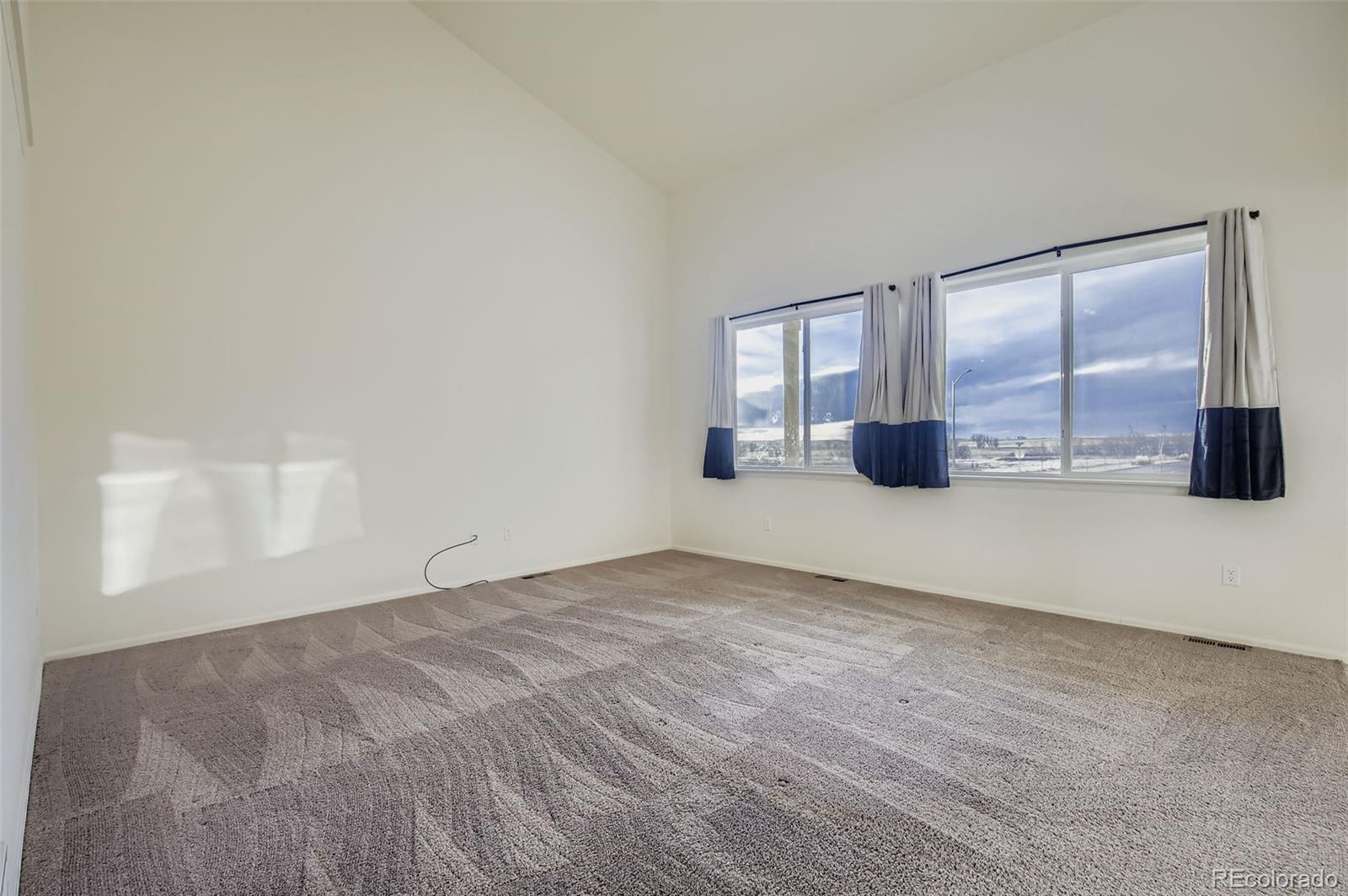 10300 19th St Road Greeley, CO 80634 - Photo 7 of 33 an empty room with wooden floor and windows