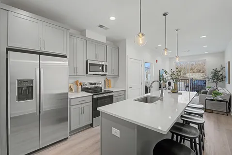 a kitchen with sink cabinets and stainless steel appliances