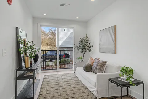 a living room with furniture and a potted plant