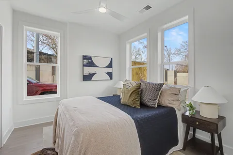 a bedroom with a bed and wooden floor