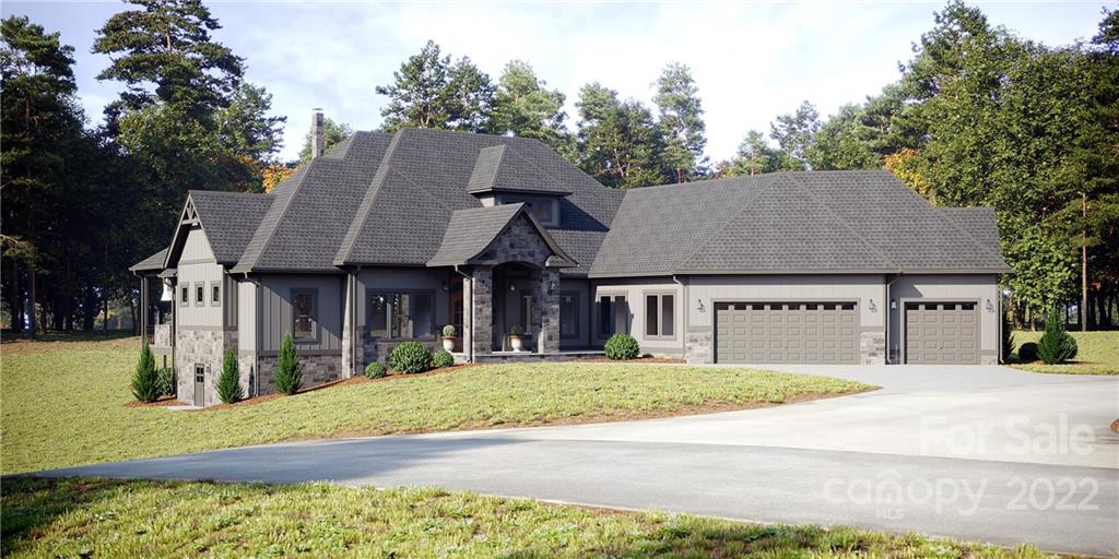 a view of a white house with a small yard and a large tree