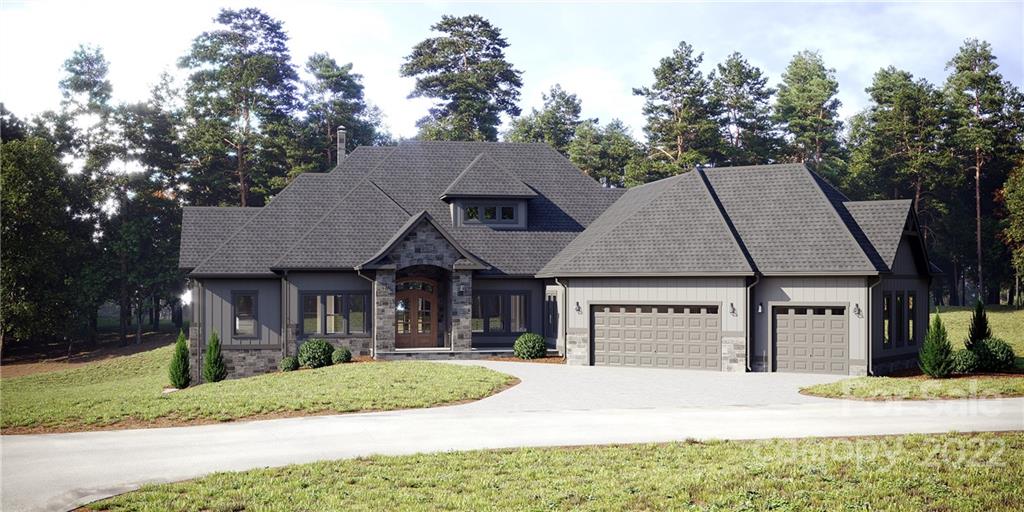 860 Daniel Cir Drive, Unit 89 Mills River, NC 28759 - Photo 2 of 5 a front view of a house with a garden and tree
