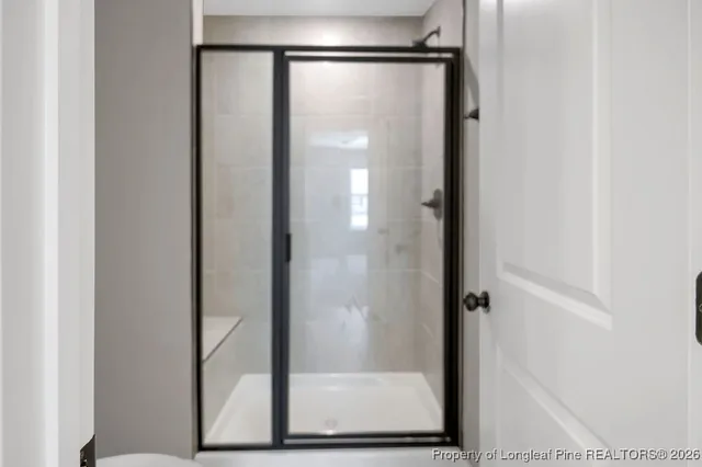 a bathroom with a glass shower door