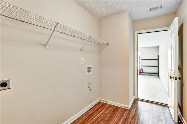 a view of a room with wooden floor