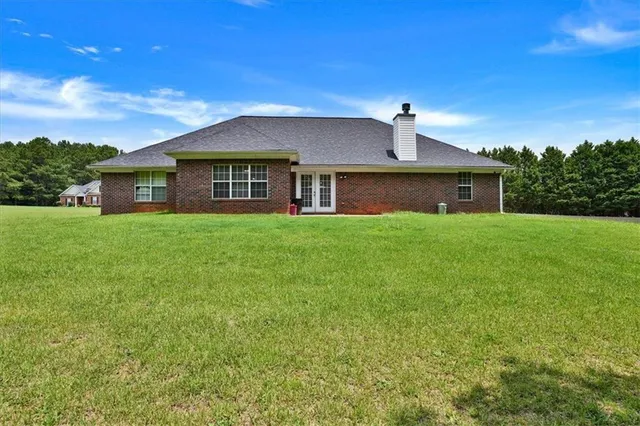 a front view of a house with yard and green space