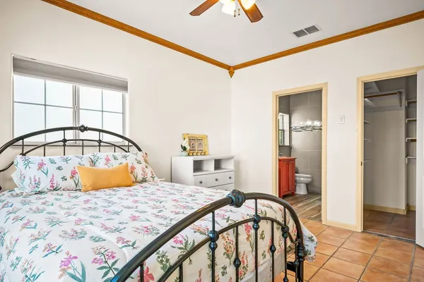 a bedroom with a bed and a chandelier