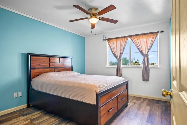 a room with a bed and wooden floor