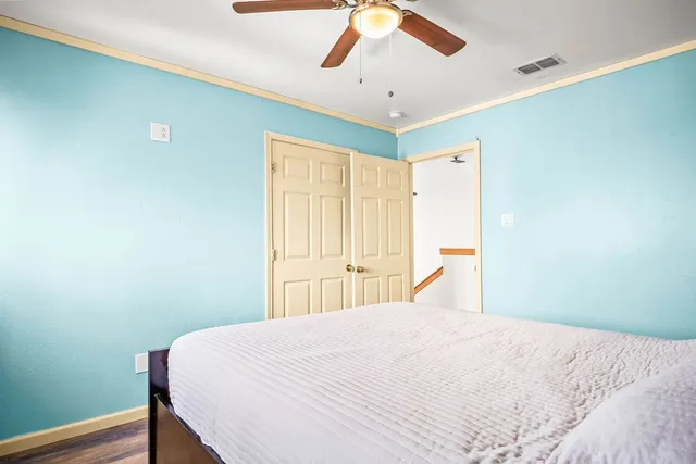 a bedroom with a bed and a chandelier