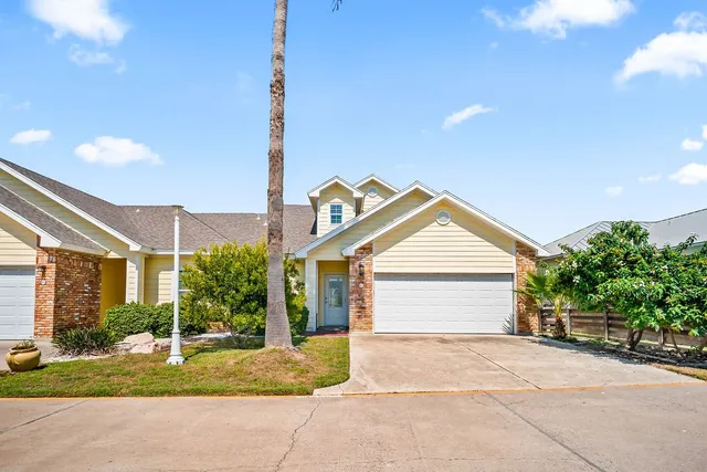 a view of backyard of house and garage