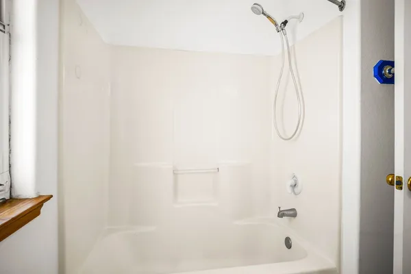 a bathroom with a shower and a shower