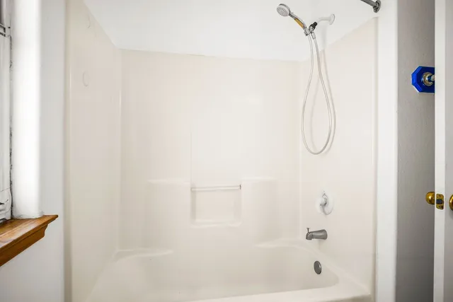 a bathroom with a shower and a shower