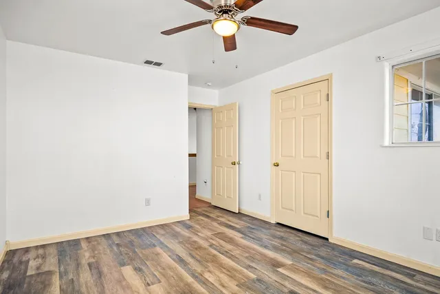 wooden floor in an empty room with a window