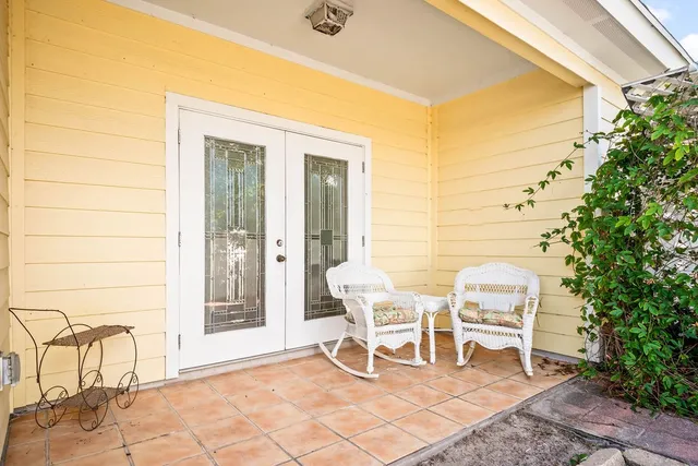 a couple of chairs sitting in front of a house