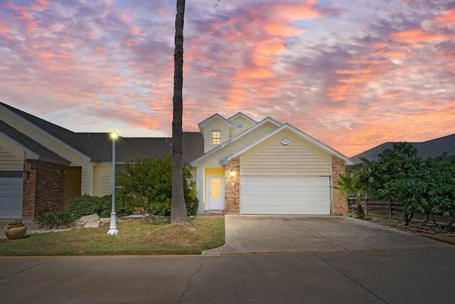 a view of a house with a yard and garage