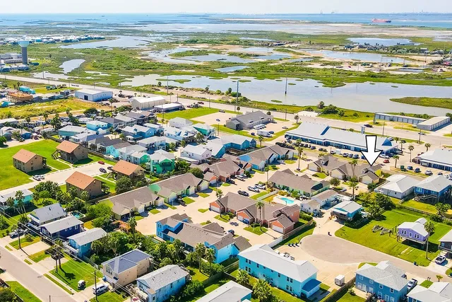 an aerial view of residential houses with outdoor space