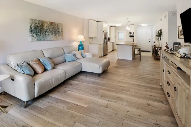 a kitchen with a table chairs refrigerator and microwave