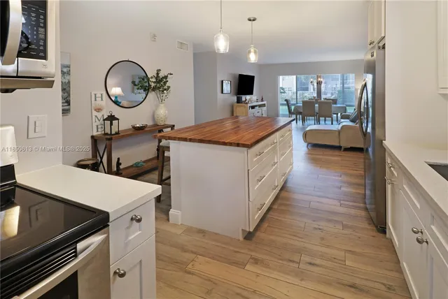 a bedroom with a bed a flat screen tv and dresser