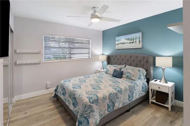 a bathroom with a granite countertop toilet sink and mirror